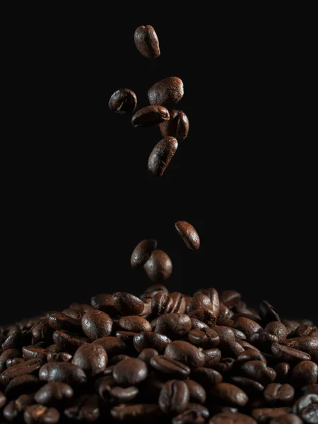 Falling coffee beans on the dark background — Stock Photo, Image