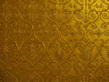 Old golden ornament on the wall. clipart