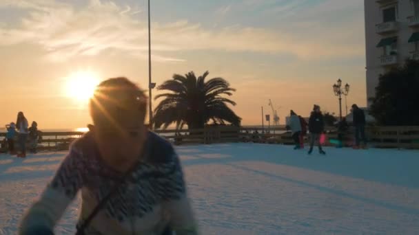 People skating on ice-rink at sunset, Greece — Stock Video