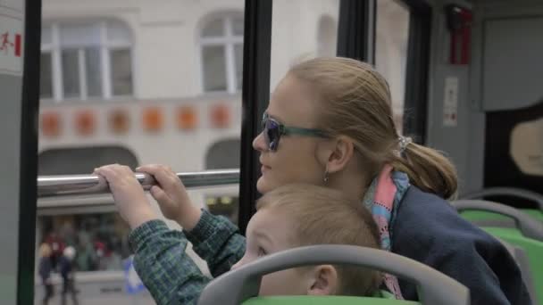 Mother and son looking at city from double-decker bus — Stock Video