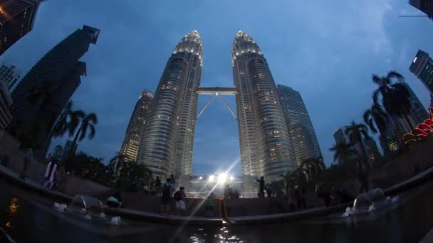 Timelapse of people by Petronas Towers from evening till night — Stock Video