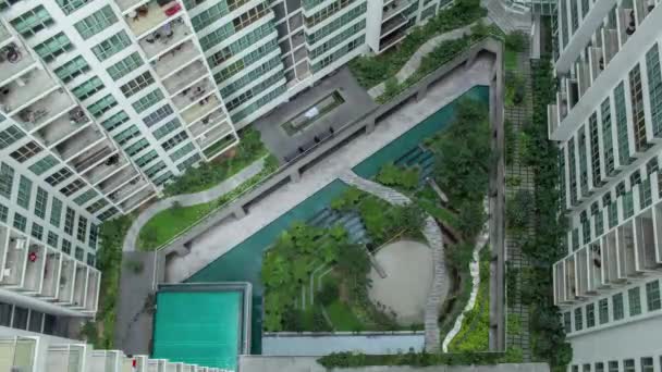 Воздушный хронометраж людей в декоративном саду за пределами жилых домов — стоковое видео