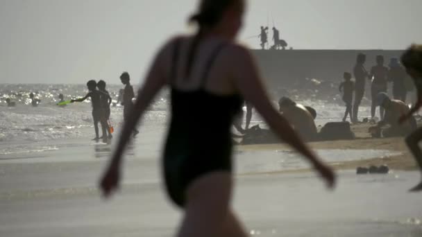 Personas que tienen un día agradable en la playa — Vídeos de Stock