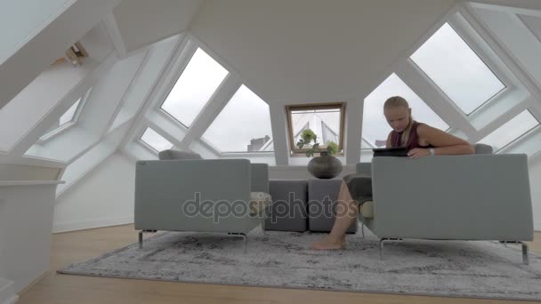 Woman with pad in the room of Cube House — Stock Video