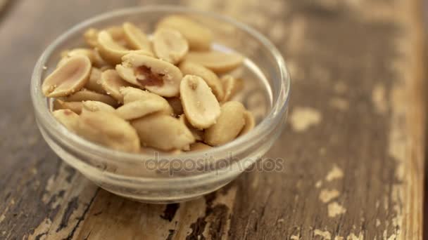 Salted peanuts in small bowl — Stock Video