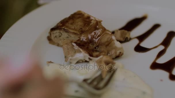 Woman eating meat roll in restaurant — Stock Video