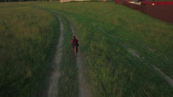 Aerial steadicam view of boy riding a bike at summer, Russia — Stock Video