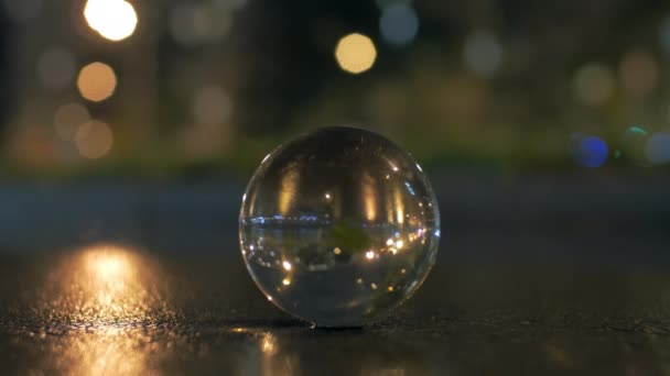 Glass sphere on the road in night city — Stock Video