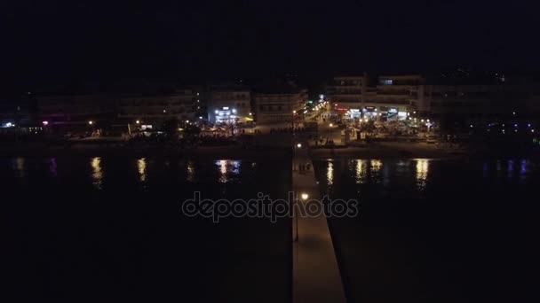 Vuelo aéreo sobre el mar alejándose de la línea de costa con el distrito turístico en Grecia — Vídeos de Stock