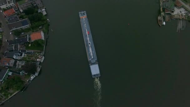 Aerial shot of barge sailing down the river in town — Stock Video