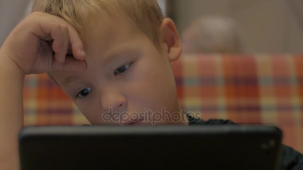 Boy spending leisure time with tablet PC — Stock Video