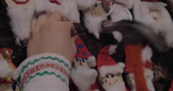 Placing Santa Claus craftwork into Christmas collection — Stock Video