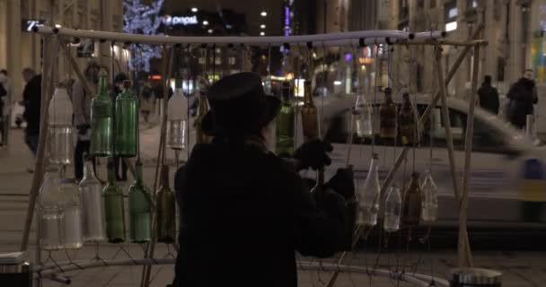 Man spelen op glazen flessen om geld te verdienen — Stockvideo