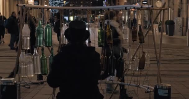 Street musician playing on glass bottles — Stock Video