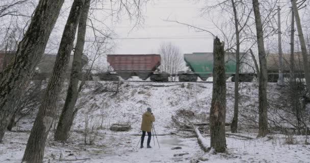 Creating footage of passing freight train in winter — Stock Video