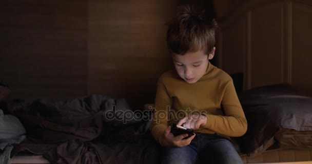 Niño con teléfono inteligente en casa — Vídeo de stock