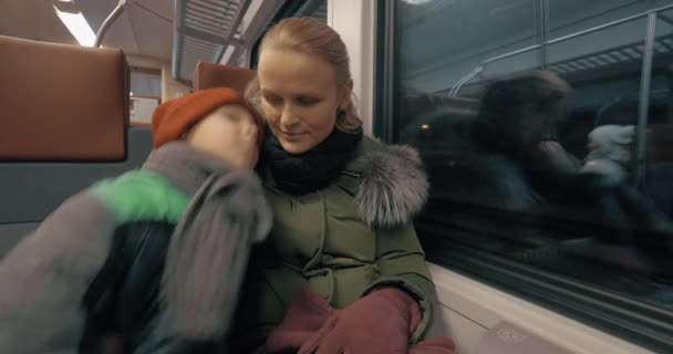 Mother and her gentle loving son traveling by train — Stock Video