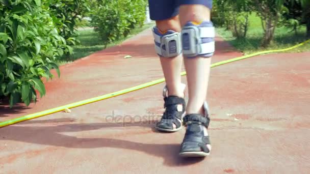 Kid with system of functional electrical stimulation — Stock Video