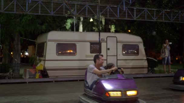 Lidé na nárazníku auta atrakcí v venkovní zábavní park — Stock video