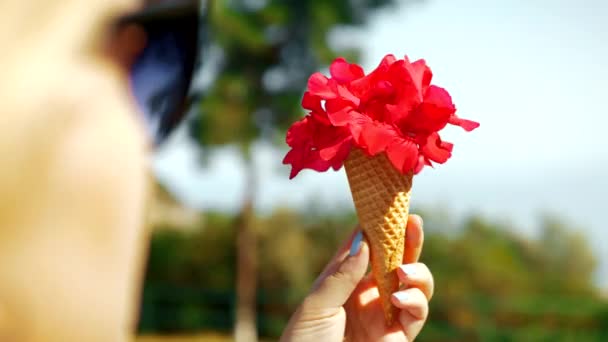 Woman holding red flowers in waffle cone — Stock Video