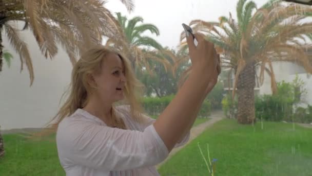 Vrolijke vrouw zomer selfie maken op regenachtige dag — Stockvideo