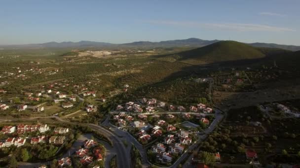 Flying over the town and green landscape with hills. Trikorfo Beach, Greece — Stock Video