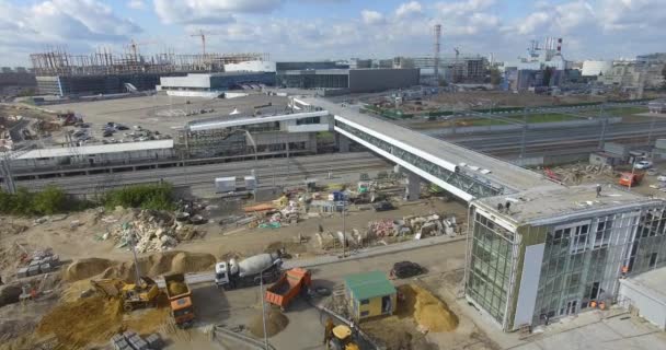 Строительство нового современного железнодорожного вокзала на окраине города, вид с воздуха — стоковое видео