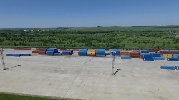 Containers stacked at storage area with gantry crane, aerial view — 비디오