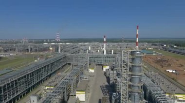 Parlak mavi gökyüzüne karşı bir petrol arıtma tesisinin havadan görünüşü