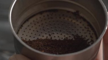 Filling in funnel with ground coffee for moka pot