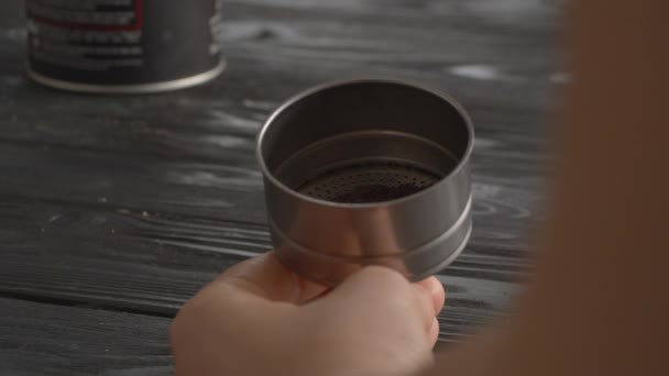 Woman filling the funnel of moka pot with ground coffee — Stock Video