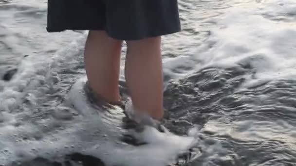 A slowmotion of waves washing childs feet — Stock Video