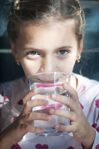 Cute little girl drinking water outdoors — Stock Photo, Image