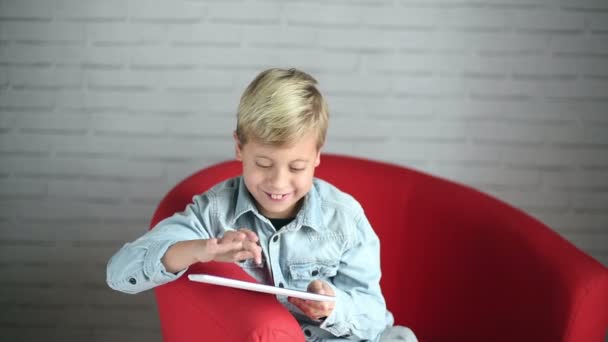 Little blonde boy playing and touching a table at home. — Stock Video