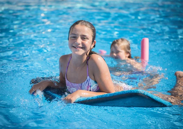Little girl is swimming in the pool on the blackboard — Stock Photo, Image