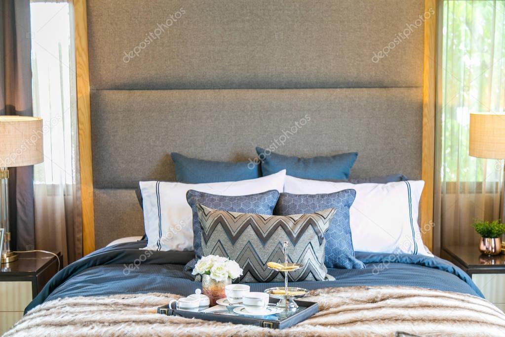 tea set on the bed with many pillow