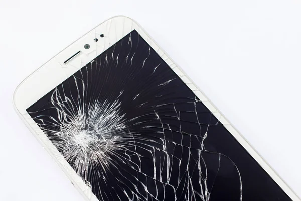 Mobile phone with broken screen on white background
