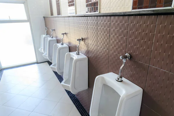 La ligne d'urinoirs dans les toilettes des hommes . — Photo
