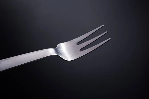 Fork in black background — Stock Photo, Image