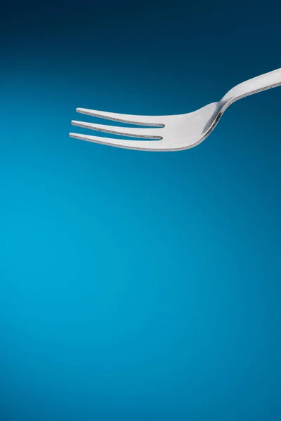 Fork in blue background — Stock Photo, Image