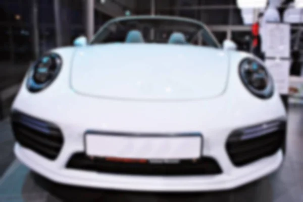 Blur image of car in the showroom use for background — Stock Photo, Image