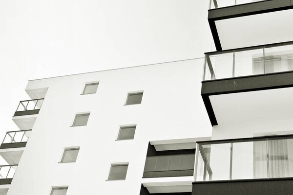 Modern apartment buildings on a sunny day with a blue sky. Facade of a modern apartment building. Black and white.