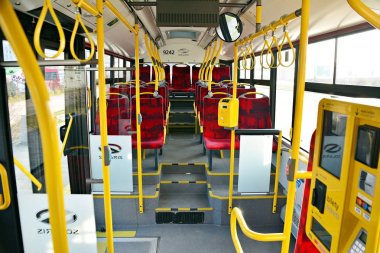 Warsaw, Poland. 4 February 2018.Interior of a city bus. Ricket validator and ticket sales machine clipart