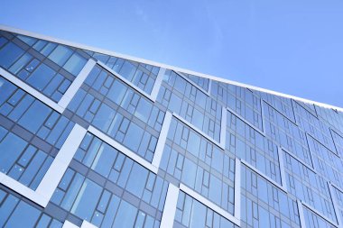 Çelik ve cam mavi gökyüzü ile modern ofis binası duvar yapılmış