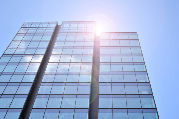 Modern office building detail, glass surface with sunlight. Business background. 