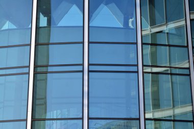 Çelik ve cam mavi gökyüzü ile modern ofis binası duvar yapılmış