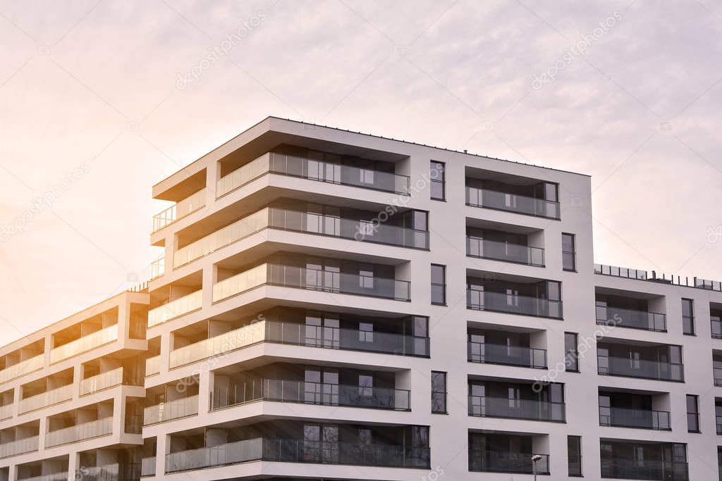 Sun rays light effects on urban buildings. Fragment of modern residential apartment with flat buildings exterior. Detail of new luxury house and home complex. 