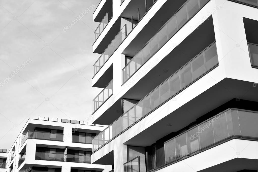 Sun rays light effects on urban buildings. Fragment of modern residential apartment with flat buildings exterior. Detail of new luxury house and home complex. Black and white.