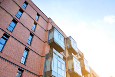 Güneş ışınları kentsel binalar üzerinde ışık etkisi yaratıyor. Düz binaları olan modern bir apartman dairesi. Yeni lüks ev ve ev kompleksinin ayrıntıları. 