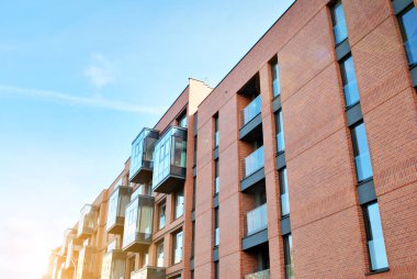 Güneş ışınları kentsel binalar üzerinde ışık etkisi yaratıyor. Düz binaları olan modern bir apartman dairesi. Yeni lüks ev ve ev kompleksinin ayrıntıları. 